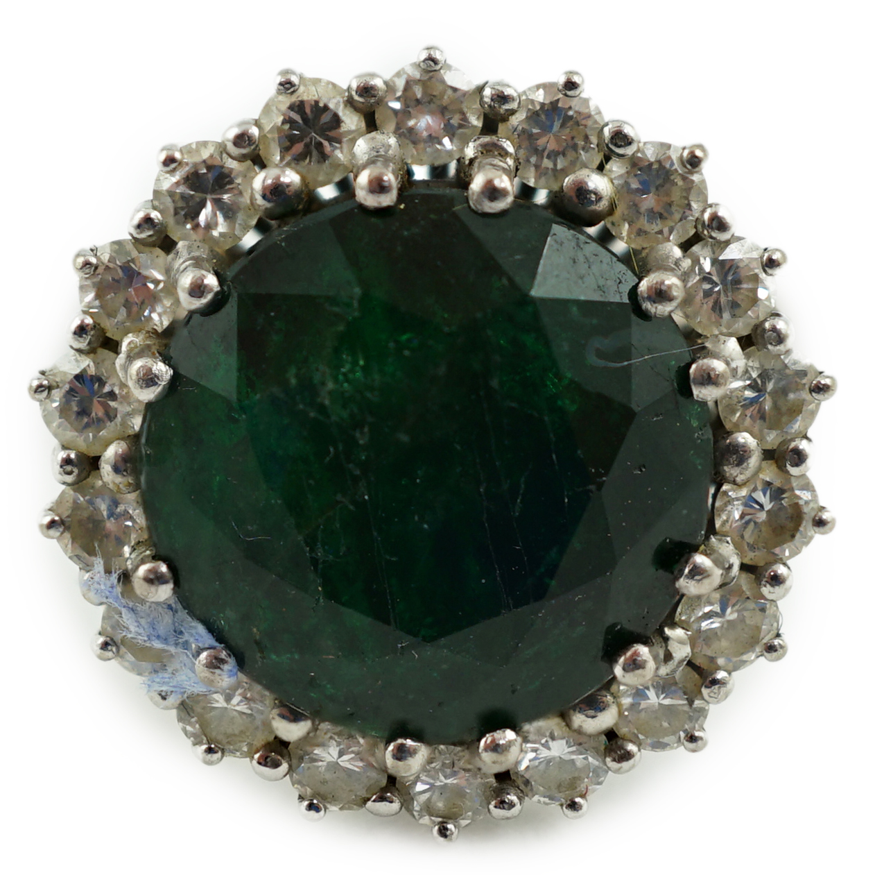 A mid 20th century 18k white gold and round cut emerald set dress ring, with diamond set border